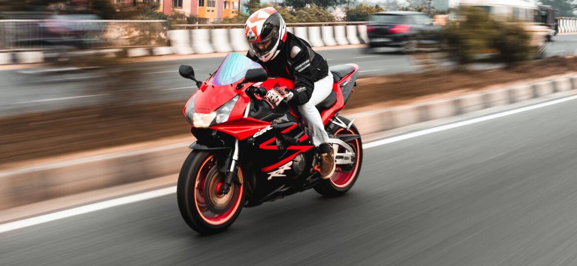 biker driving fast on highway