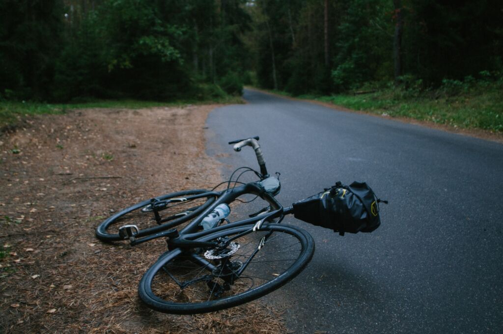 bicycle lying next to trail
