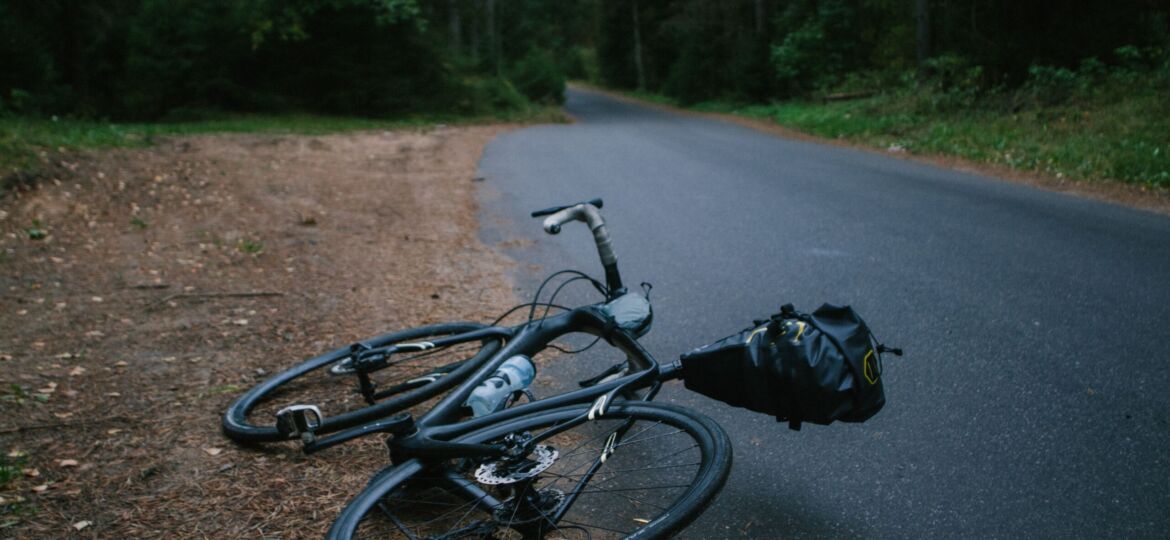 bicycle lying next to trail