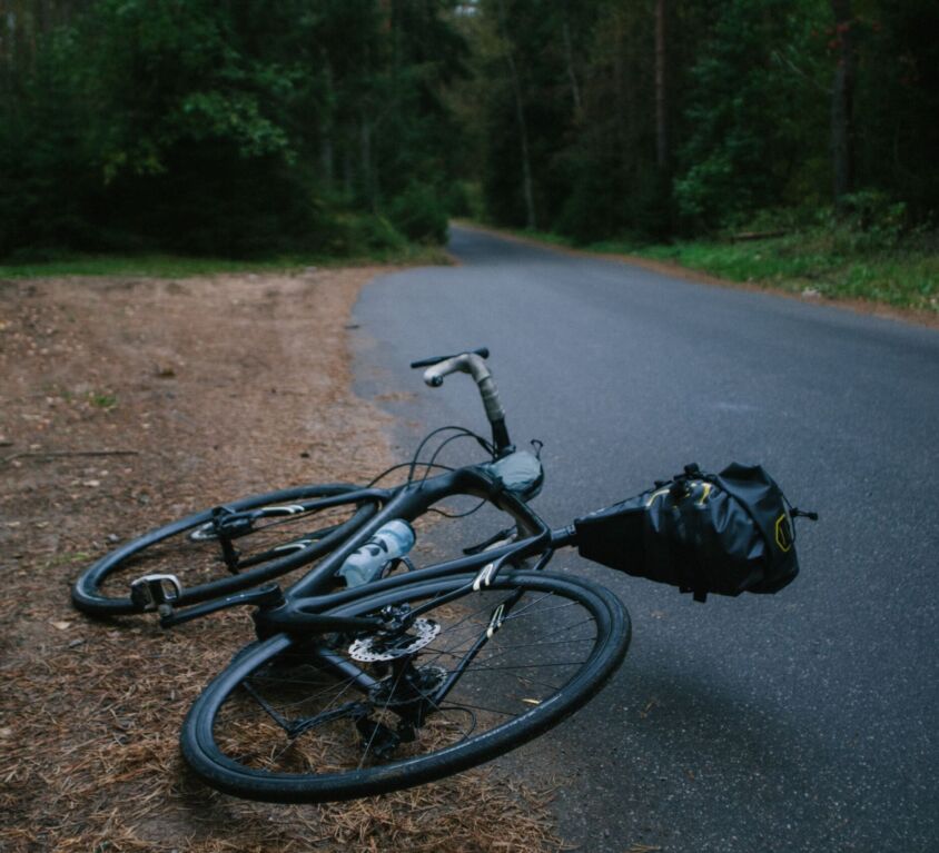 bicycle lying next to trail