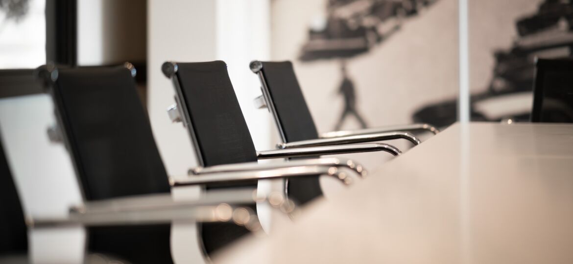 chairs at large table in conference room