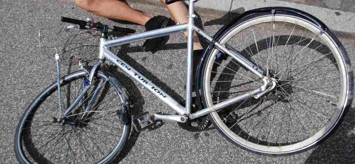 man lying on the ground injured after a bicycle accident