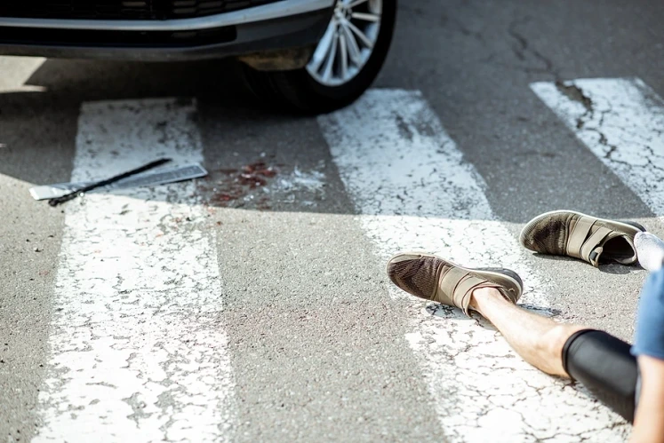 Persona on crosswalk knocked over by car